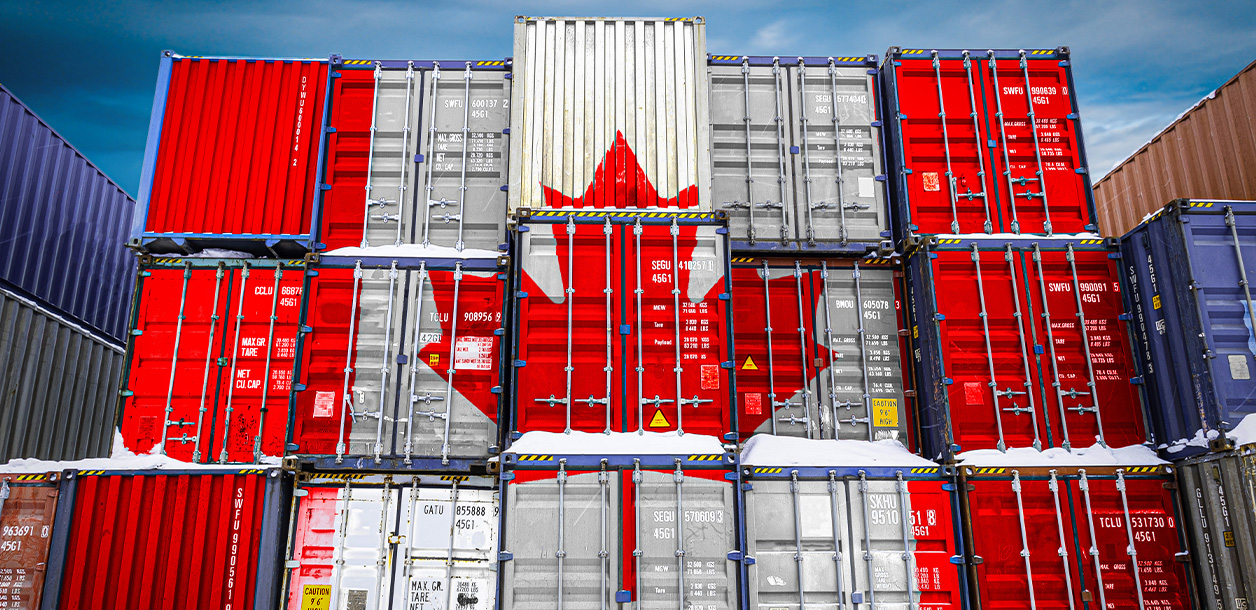 Stack of shipping containers with a Canadian flag painted on the side