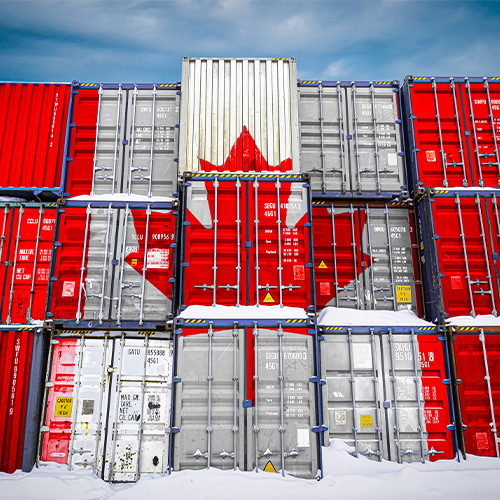 Stack of shipping containers with a Canadian flag painted on the side