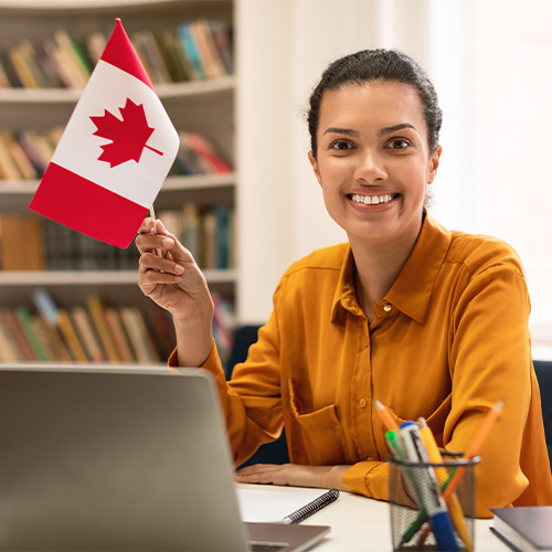 Smiling girl holding Canadian flag